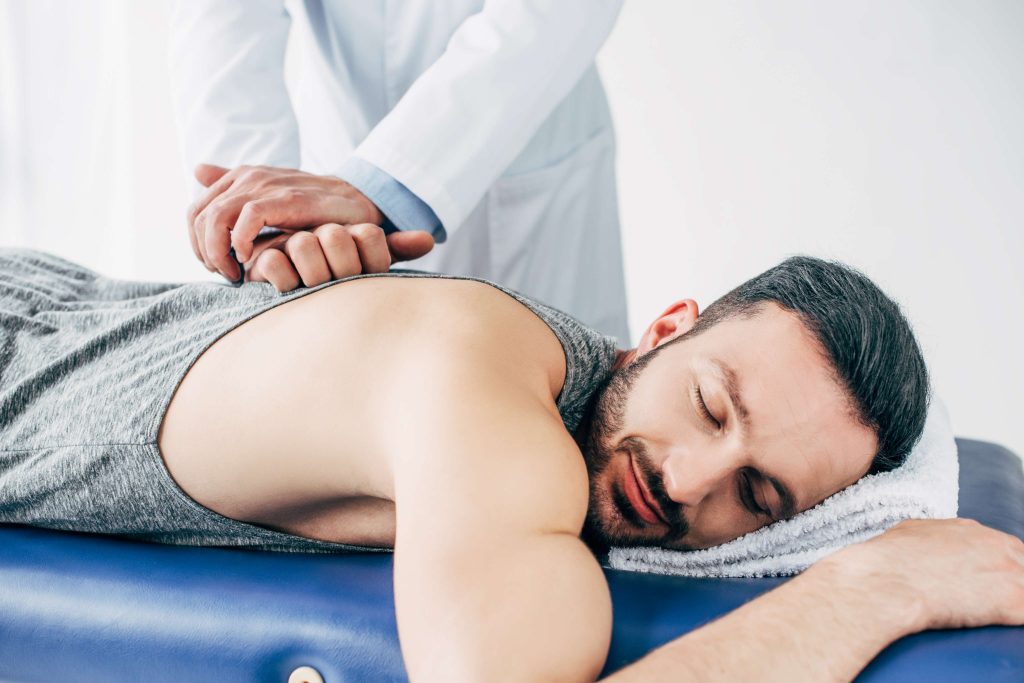vistacreate 268407822 stock photo chiropractor massaging back man lying massage table hospital(1)