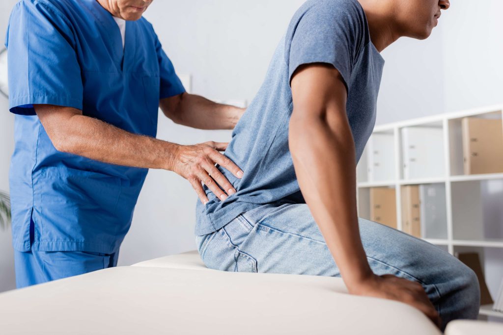 vistacreate 437790346 stock photo cropped view mature chiropractor working african american man(1)