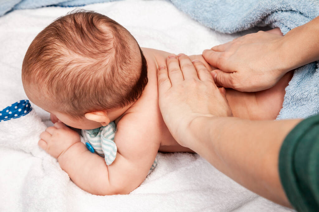 five month baby girl receiving massage therapy home lockdown osteopathic