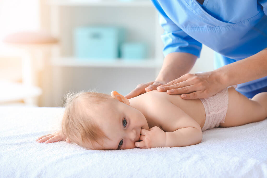 massage therapist working cute baby medical center