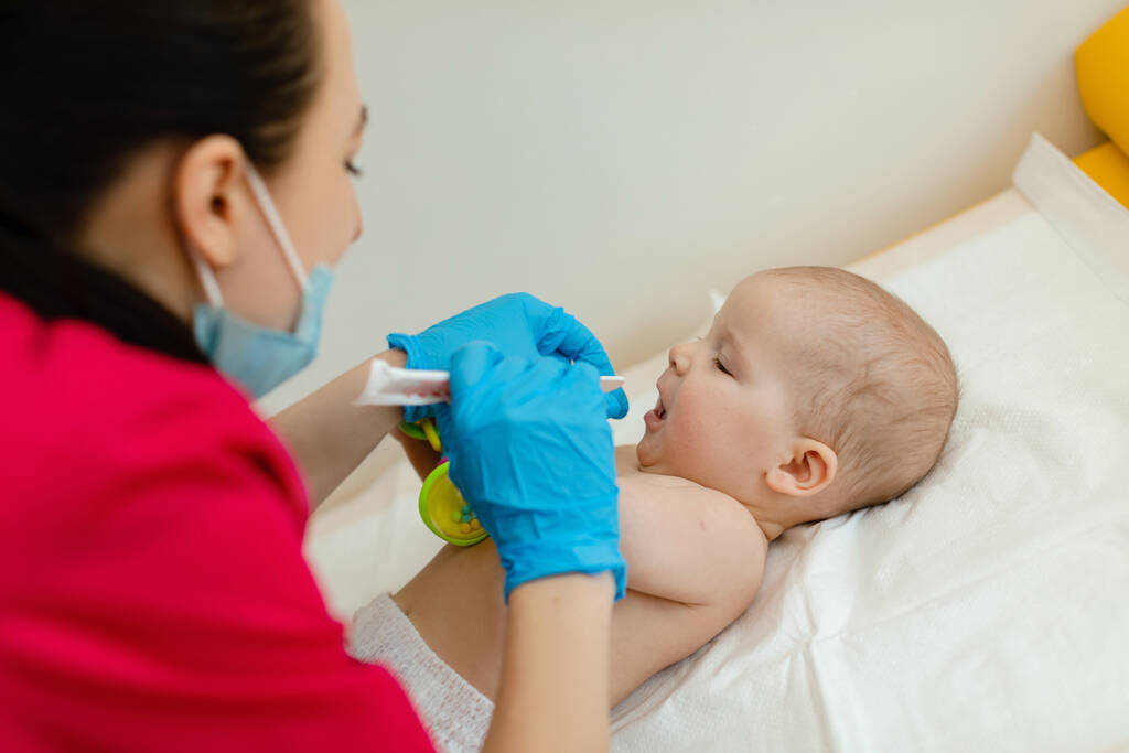 pediatrician examining baby girl doctor using stethoscope listen child heartbeat