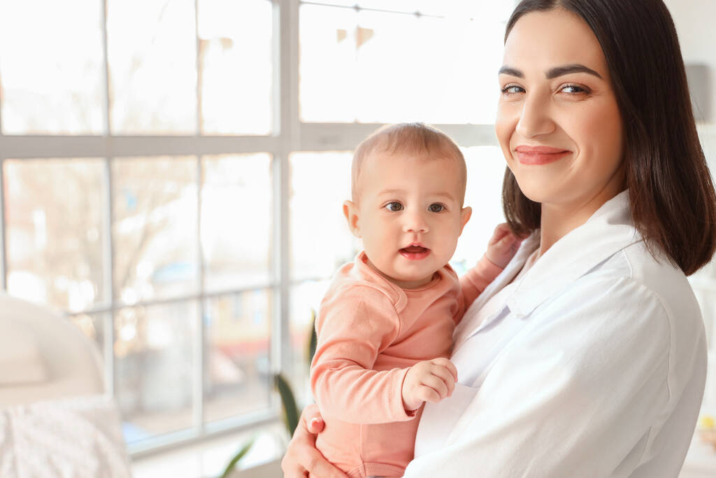 portrait female pediatrician little baby clinic closeup